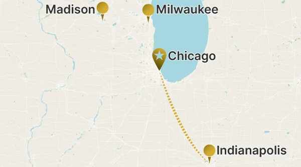 A regional map of the Midwestern United States showing a long-distance route between Chicago (marked with a star pin) and Indianapolis, indicated by a dotted line. Madison and Milwaukee are also marked as points of interest.