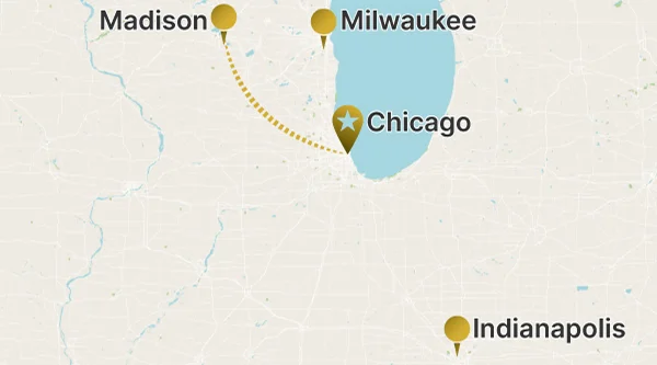 A regional map of the Midwestern United States showing a long-distance route between Madison and Chicago (marked with a star pin) indicated by a dotted line. Milwaukee and Indianapolis are also marked as points of interest.